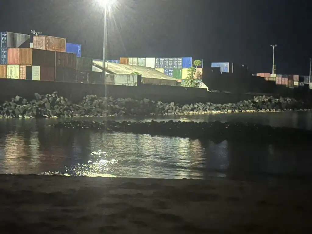 Nighttime view of the São Tomé City PM beach adjacent to the port area, an authentic sight for the São Tomé City Guide.