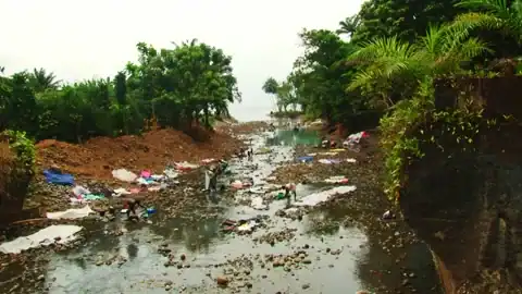 Sao tome laundry in the river - part of the scene on a South Tome Road Trip